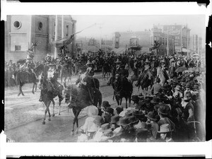 Caballeros and señoras in front of the Plaza Church during La Fiesta de Los Angeles, 1901