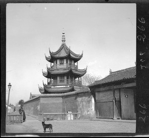 Exterior view of a pagoda with dog and pedestrians, China, ca.1900