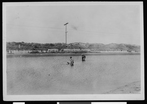 Department of Public Works workers wading in a river, ca.1900