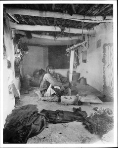 Hopi Indian weaver making a ceremonial kilt in Oraibi, Arizona, ca.1900