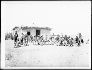 Yuma Indian council in front of a native dwelling, ca.1900