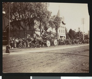 Parade with floats and flags flying, ca.1920