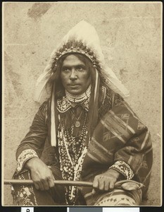 Male Indian wearing a feather headdress, ca.1900