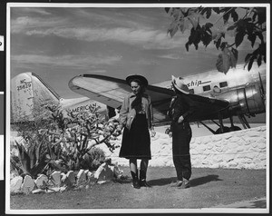 American Airlines airliner, showing two women posing in the foreground, ca.1940
