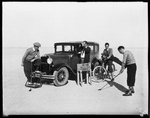 Men golfing near an automobile