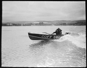 Man in a motorboat which bears the name "Coff Drop" at the Los Angeles Harbor, ca.1928