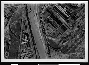 Aerial view of a swollen Los Angeles River showing the the Southern Pacific Shops and its Alhambra Avenue roundhouse, Los Angeles, 1938