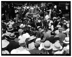 "Wedding of the rails", showing photographers around a man hammering a railroad spike, 1926