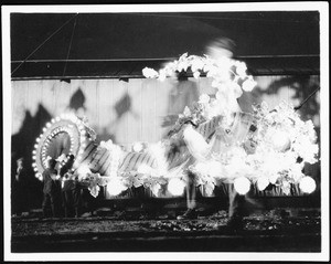 Panama-Pacific International Exposition in San Francisco, showing men carrying a night float, 1915