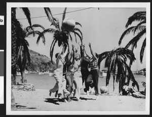 Women tossing a ball in the air at a Los Angeles area beach, ca.1930