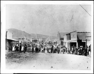 Citizens of Randsburg, including the fire department, gathered in the streets of the city, ca.1898