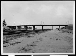View of railroad tracks under a concrete viaduct in Los Angeles