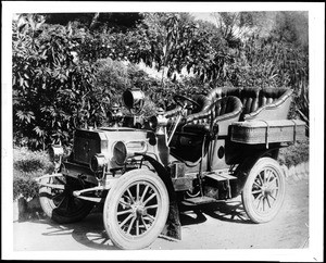 Early model Tourist automobile parked on the side of a dirt road, ca.1905