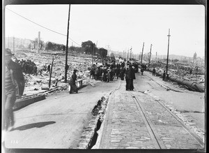 The site of the Valencia Hotel, showing people searching for buried dead in the earthquake damage, San Francisco, 1906