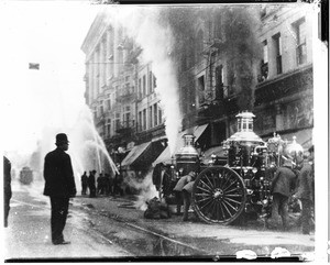 Fire fighters and steam-powered fire engines in action on Broadway, Los Angeles, ca.1914