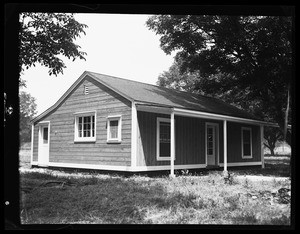 An exterior view of a one bedroom house, showing a porch entrance