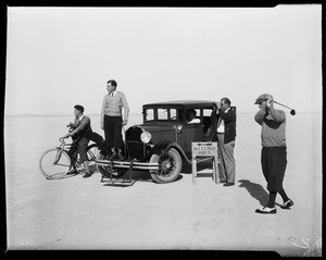 Men golfing near an automobile