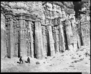 View of Red Rock Canyon showing flute rock formations and two travelers, Death Valley, California, ca.1900/1950