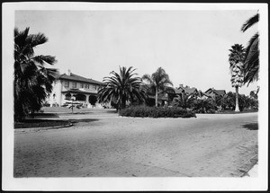 Street of two-story homes with an island parkway