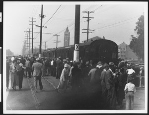 Crowd gathering around a train at a station, ca.1930-1940