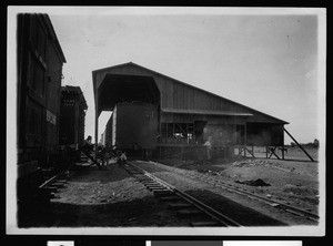 Packing shed and railroad at Heber, ca.1910