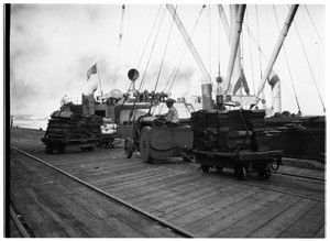 Tractor transporting lumber at the Los Angeles Harbor docks, 1926