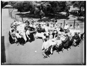 Picnic at an ostrich farm in Lincoln Park showing a chef serving roast ostrich