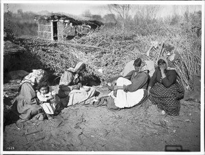 Group of Chemehuevi Indian women and a child, sitting on the ground, ca.1900