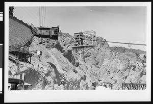 Construction of Boulder Dam, showing a work site on a canyon wall, ca.1930