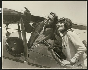 W.E. Thomas and woman posing in open cockpit, ca.1925