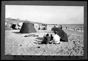 Beach-goers near tents and beach umbrellas, south of the pier, Playa Del Rey, ca.1924