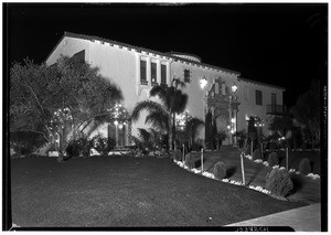 Outdoor Christmas decorations, showing strings of lights on windows, December 26, 1930