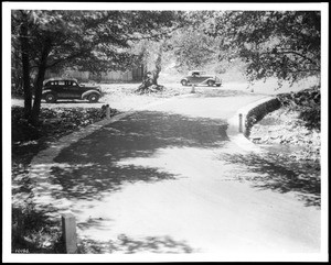 Two cars parked next to Banner Creek near Julian in San Diego County, ca.1938