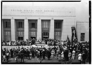 Speaker addressing a crowd in front of the United States Post Office Hollywood Station