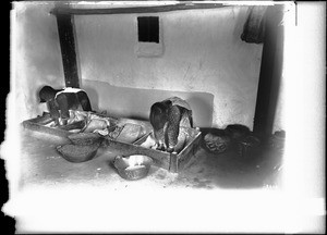 Two young women grinding corn, Pueblo of Laguna, New Mexico