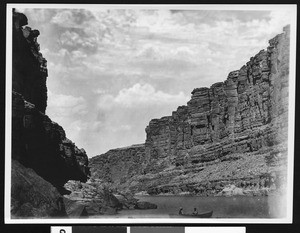 Small boat crossing the Colorado River at the entrance to Marble Canyon, Grand Canyon, 1900-1930