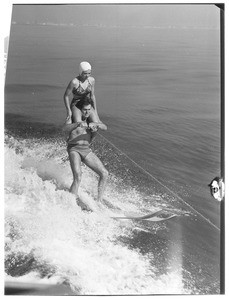 A man and woman water skiing