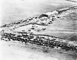 Aerial view looking southeast on crowds at Sid Chaplin's airport at the intersection of Wilshire Boulevard and Fairfax Avenue, Los Angeles, 1920