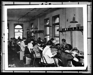 Women working at sewing machines in a garment factory in Los Angeles, ca.1928