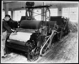 Man tending to a machine in an unidentified factory