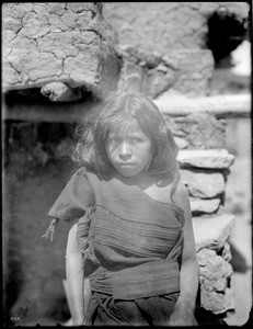 Young Hopi Indian girl sitting outside, ca.1900