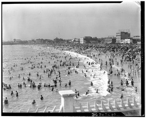 People playing in the surf at an unidentified beach