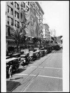 View of the Broadway Department Store decorated with signs and bunting welcoming the Shriners to Los Angeles, ca.1925