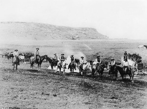 Portrait of an outfit of cowboys at their camp, 1898