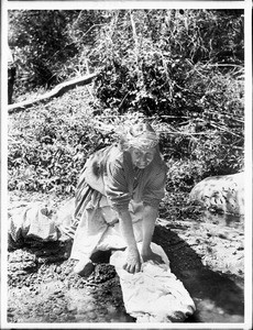 Coahuilla Indian woman washing clothes in a stream, Warners Hot Springs, ca.1905