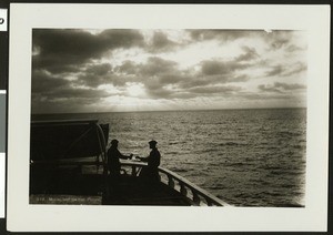 Two men on a boat under moonlight on the Pacific Ocean, 1907