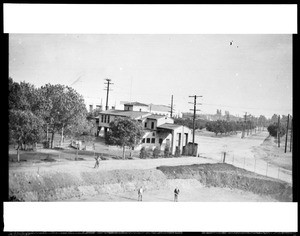 View of the entrance to the Los Angeles County Fair, showing a four-way street intersection, ca.1930