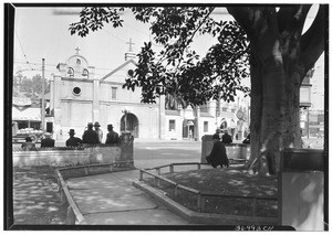 Exterior view of the Plaza Church, showing men in the street in the foreground