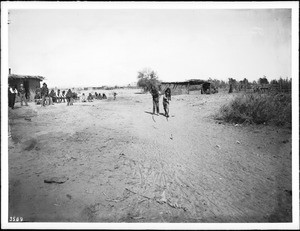 Two young Yuma Indian men playing the pole and hoop game, ca.1900