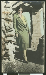 Woman holding a cigarette and standing, ca.1930